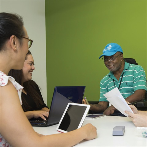 People sitting around a table using a Study Rooms